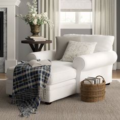 a living room with a white couch and fireplace