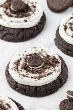 oreo cookies with white frosting and oreos in the middle on a marble surface