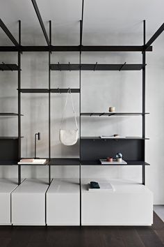 a room with shelves and hanging items on the wall