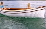 two people in a small boat on the water