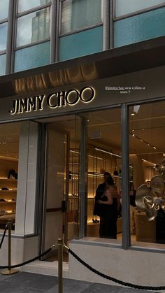 the entrance to jimmy choo store in new york city, with people standing outside