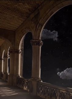 an empty room with pillars and arches under the stars in the night sky above them