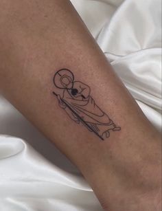 a person with a tattoo on their arm is holding a knife in the shape of a koala