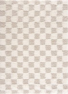 an area rug with squares on it in beige and white colors, made from thick wool