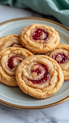 A fun twist on classic peanut butter cookies, filled with sweet jelly! These cookies are the ultimate treat. #PeanutButterAndJelly #CookiesRecipe #DeliciousDesserts