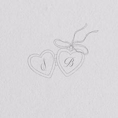 two hearts with the letter s on them are drawn in pencil and placed next to each other