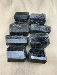 black marble blocks stacked on top of each other in the shape of rectangles