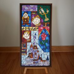 a stained glass window with an image of a castle