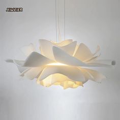 a white light fixture hanging from a ceiling