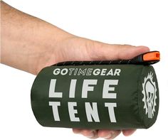 a hand holding a green and white bag with the words go time gear on it