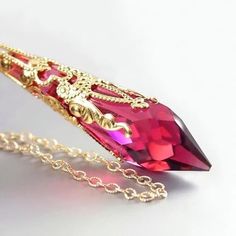 Pink Ruby pendant necklace featuring brilliant RARE Swarovski crystal prism in gold filigree suspended from 14K Gold fill chain. Nice gift idea for July birthday lady :) More details: - 14K GOLD FILLED (not plated) elegant chain, wire, and lobster claw clasp. - Brilliant Swarovski faceted crystal teardrop in Red/Pink Ruby, 40mm x 11mm - Charming Filigree Cone (Genuine 22K Gold is plated on to an intricate brass filigree), Nickel and Lead-free - Raspberry Czech Crystals - The Pendant is approx. 2 Birthday Lady, Xman Marvel, Ruby Pendant Necklace, Victorian Style Jewelry, Ruby Necklace Pendant, Pink Ruby, Ruby Crystal, Swarovski Crystal Necklace