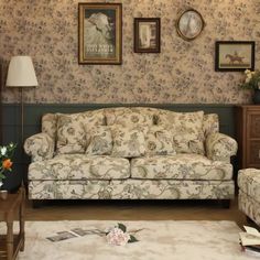 a living room filled with furniture and pictures on the wall