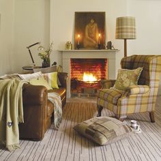 a living room filled with furniture and a fire place next to a painting on the wall