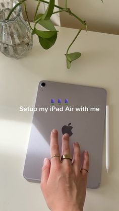 a woman's hand on an ipad with the text setup my ipad air with me