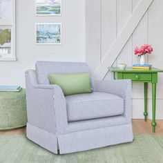 a living room with a green table and blue chair