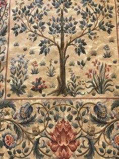 an intricately designed rug with trees and flowers