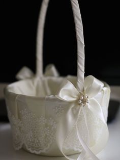 a white basket with a bow on it