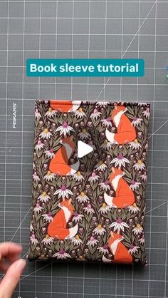 someone is cutting out the pattern for a small wallet