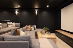 a living room filled with furniture and a flat screen tv mounted to the side of a wall