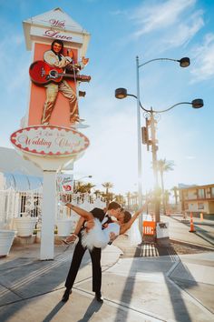 a man and woman pose in front of a sign for the famous las vegas casino