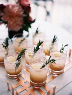 small glasses filled with drinks sitting on top of a table