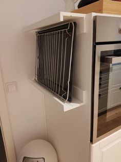 an oven is built into the side of a wall with a grill on it's door