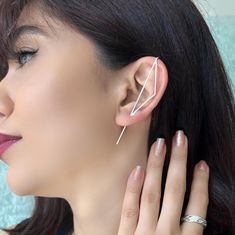 These striking Sterling Silver ear cuffs take earring design to another dimension. Handcrafted, the Triangle design has a great geometric profile, and we offer two lengths to suit different ear sizes, as well as offering this style as a single earring or as a pair. The ear pin also comes in Sterling Silver, 18kt Gold or Rose Gold plated, or in a gunmetal coloured oxidized Sterling Silver finish. A great earrings style for those looking for unusual or unique earrings. Made from: Sterling silver. Silver Ear Cuffs, Ear Pins Earrings, Ear Pin, Pin Earrings, Ear Pins, Silver Ear Cuff, Ear Climbers, Climber Earrings, Punk Jewelry