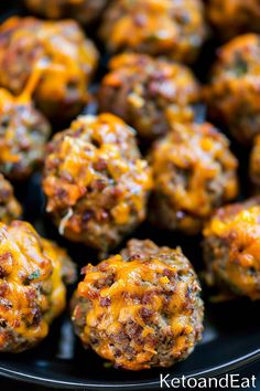 cheese stuffed meatballs on a black plate