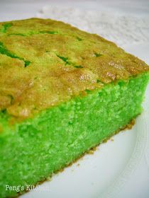 a piece of green cake sitting on top of a white plate