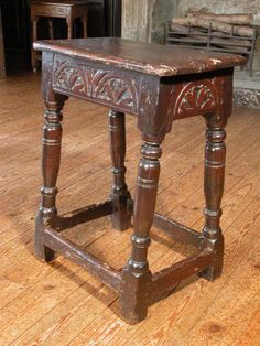 an old wooden table sitting on top of a hard wood floor