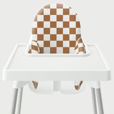 a brown and white checkered highchair seat cover on a baby's high chair