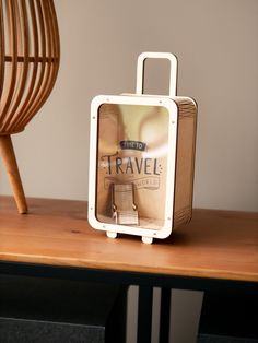 a suitcase sitting on top of a wooden table