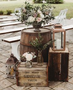 a wooden barrel with flowers and candles on it