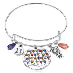 PRICES MAY VARY. Stranger Things Bracelet - This colorful bangel bracelet with charms:26 alphabet letters, flower,"11", blue orange,demogorgon,they looks exactly like in the movie, right color, same pattern. This is a very nice item for cosplay of collection, great gift for for women girls. This Alphabet Light Wall Monster premium jewelry gives attractive look which definitely capture's your friends' attention. Movie fan or collector of Stranger Things TV serial and if you really want to take yo Stranger Things Bracelet, Stranger Things Jewelry, Stranger Things Merchandise, Alphabet Jewelry, Wrist Accessories, Premium Jewelry, Costume For Women, Stranger Things Tv, Letter Bracelet