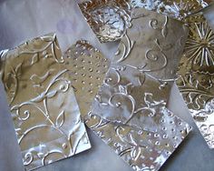 four pieces of metal with designs on them