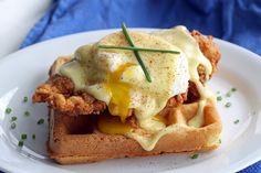 a chicken and waffle sandwich on a white plate