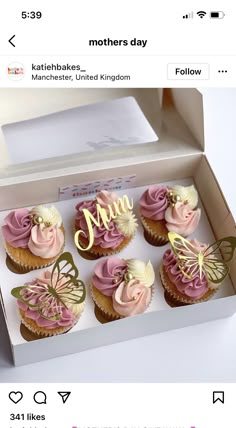 a box filled with cupcakes covered in pink frosting and gold lettering that says mum