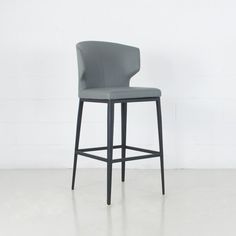 a gray bar stool sitting on top of a white floor