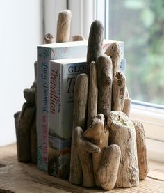 a bookend made out of driftwood sitting on top of a window sill