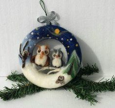 an ornament with two owls sitting on top of it