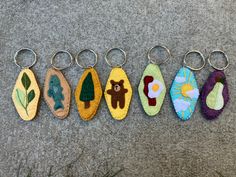 five keychains are lined up on the ground