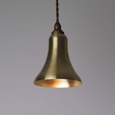 a brass colored light hanging from a ceiling