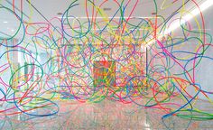 a room filled with lots of different colored wires on the floor and walls in front of it