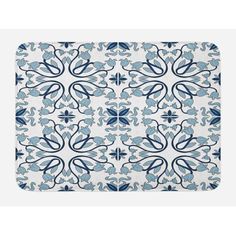 a blue and white placemat with an ornate design on it's surface, in the shape of a flower