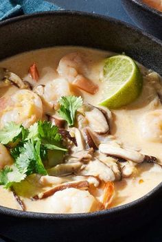 a close up of a bowl of food with shrimp and vegetables on the side,