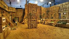 an indoor area with stone walls, stairs and steps in the sand at night time