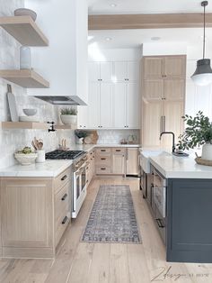 a kitchen with wooden cabinets and white counter tops, along with a rug on the floor