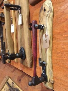 two wooden skis are hanging on the wall next to other woodworking tools and equipment