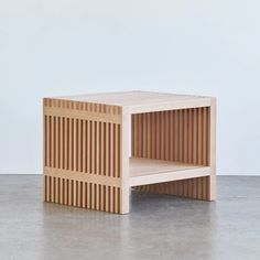 a wooden side table with vertical slats on it