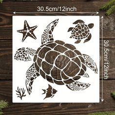 the sea turtle and starfish stencil is shown on a wooden surface with pine branches